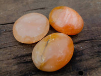 Polished Orange Twist Calcite Palm Stones x 24 From Madagascar - Toprock Gemstones and Minerals