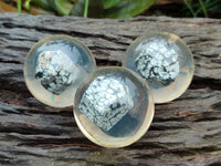 Polished Snowflake Obsidian pieces in PVC Resin Spheres - sold per item - From Mexico