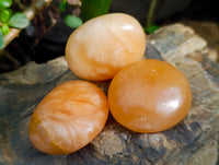 Polished Orange Twist Calcite Palm Stones x 25 From Maevantanana, Madagascar