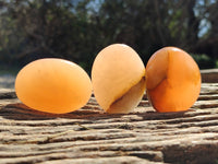 Polished Orange Twist Calcite Palm Stones x 24 From Maevantanana, Madagascar