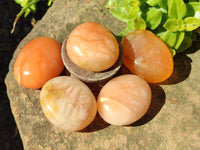 Polished Orange Twist Calcite Palm Stones x 24 From Maevantanana, Madagascar