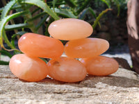 Polished Orange Twist Calcite Palm Stones x 24 From Maevantanana, Madagascar