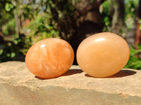 Polished Orange Twist Calcite Palm Stones x 24 From Maevantanana, Madagascar