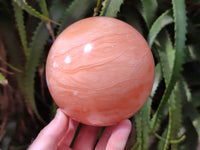 Polished Orange Twist Calcite Sphere x 1 From Maevantanana, Madagascar